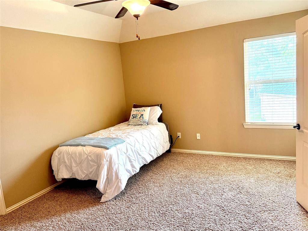 A secondary upstairs bedroom leads into another bedroom through a jack and Jill bathroom.