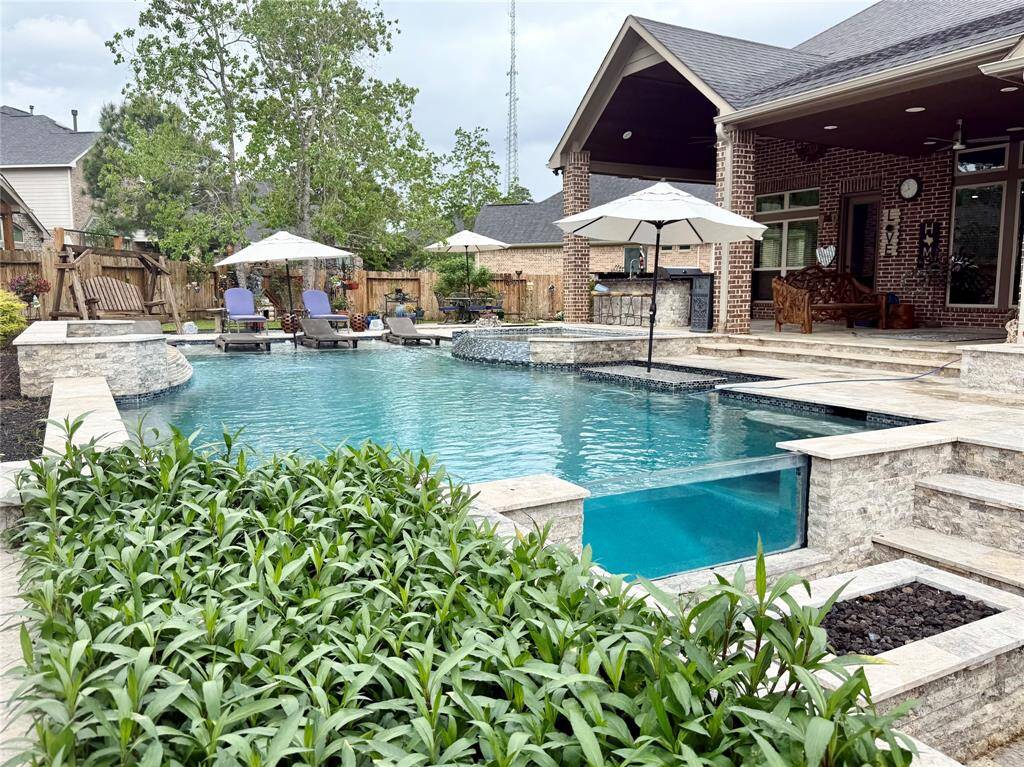 The pool boasts a gas fire pit with a view into the pool through a glass wall!!