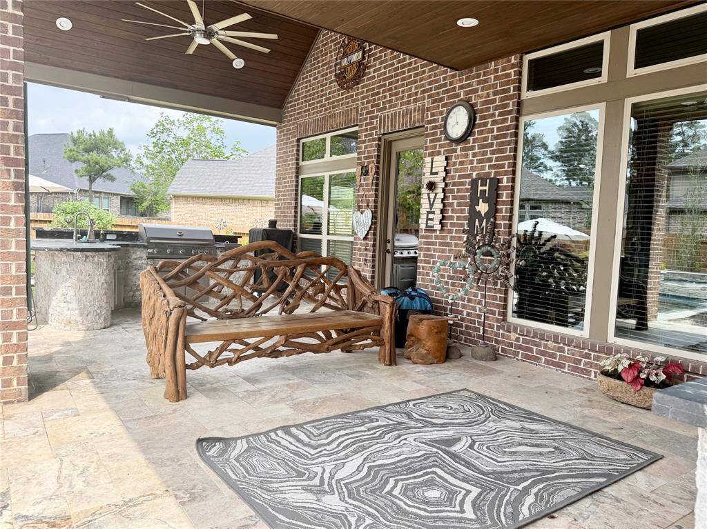 Relaxing back porch overlooking this backyard oasis!