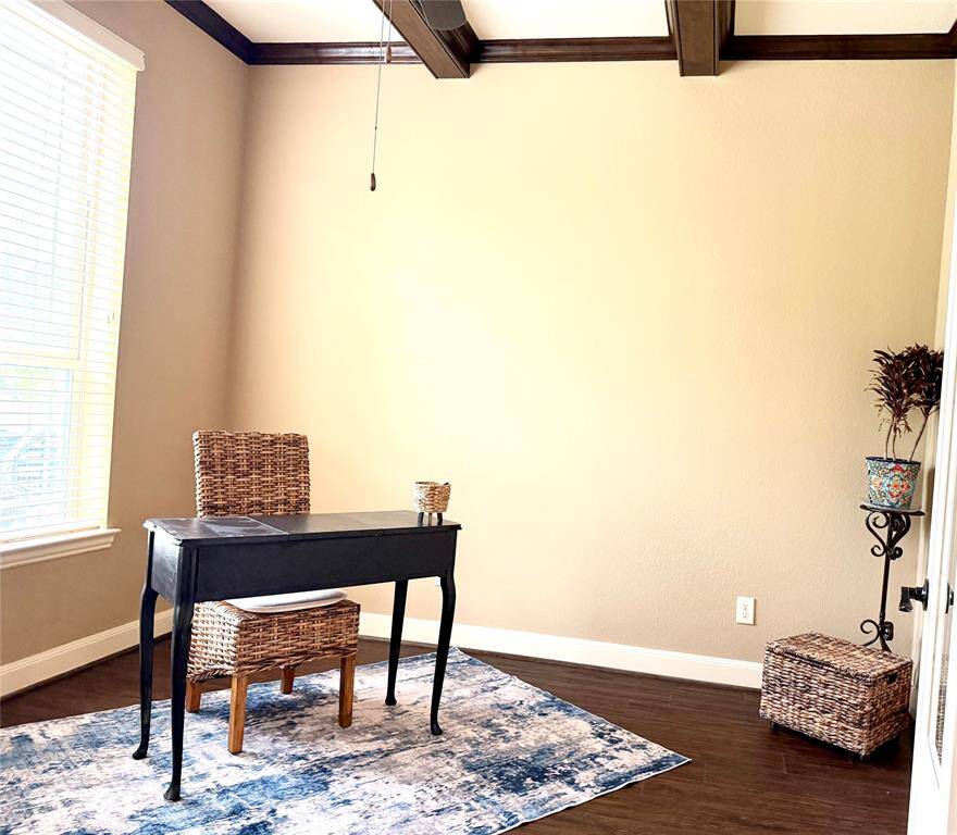The study is to the left of the entryway.  Look at those gorgeous ceiling beams!