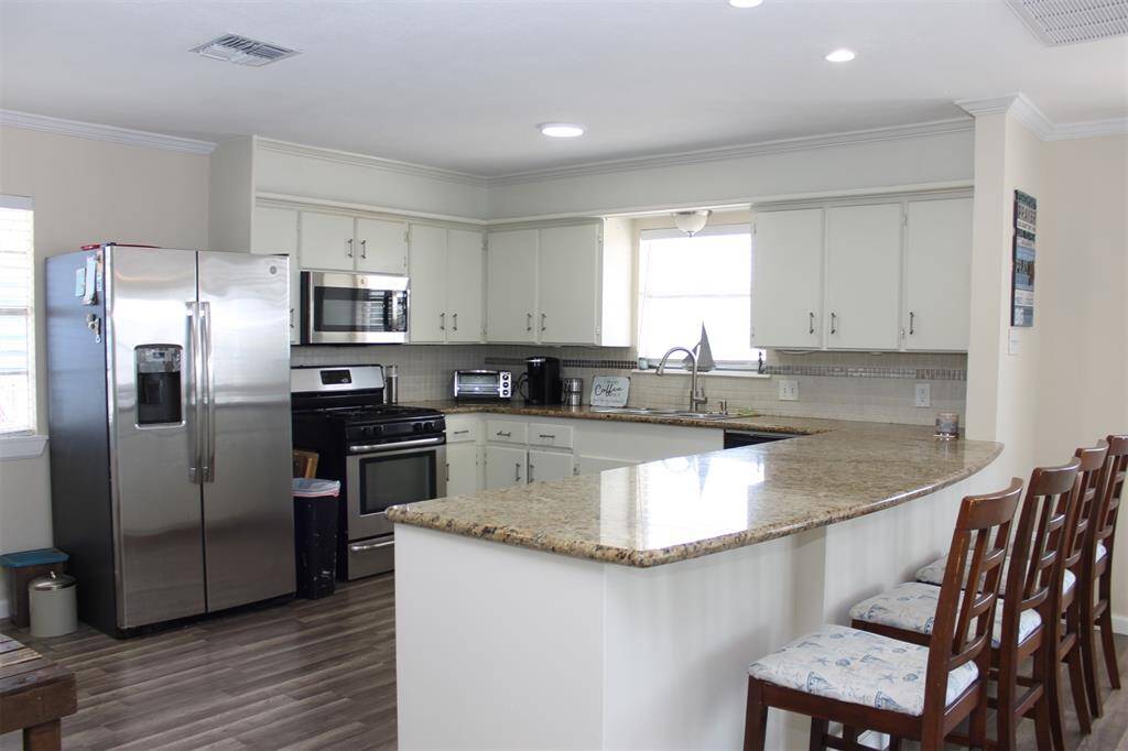 Open kitchen with lots of counters and cupboards for storage