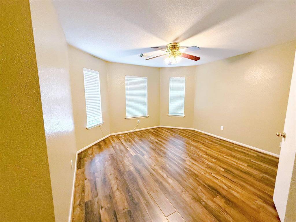 The Primary Bedroom, along with the other bedrooms, have the same easy upkeep flooring as the living room