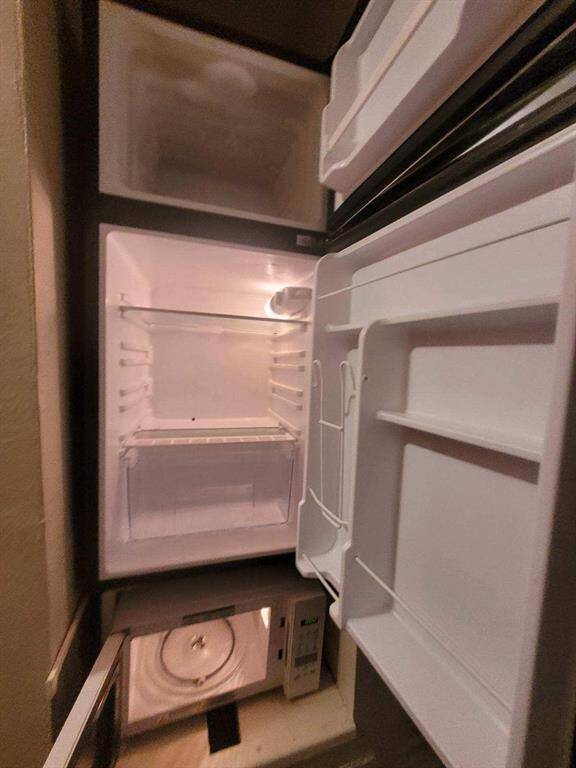 Refrigerator and microwave included.