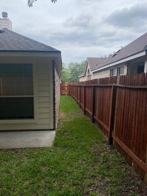 Nice roomy space with full sized washer  and dryer with shelf and hanger on adjacent wall