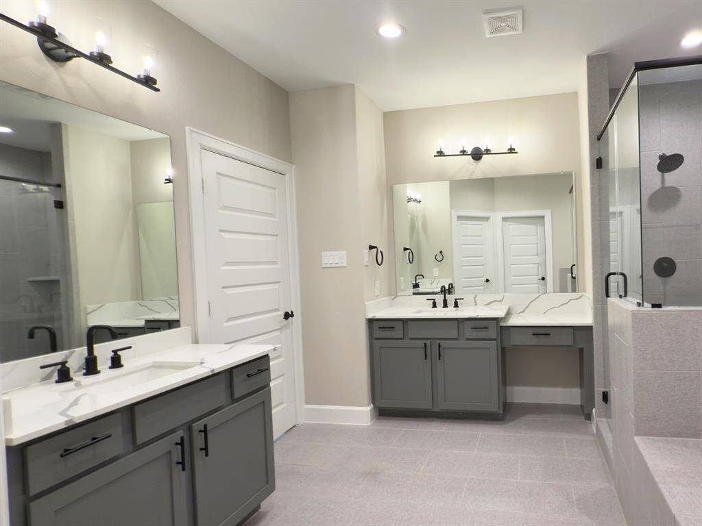 The ROCbrook’s primary bathroom boasts stylish dual sinks, providing both elegance and practicality for a seamless, stress-free morning routine. *Image depicts home as-is.