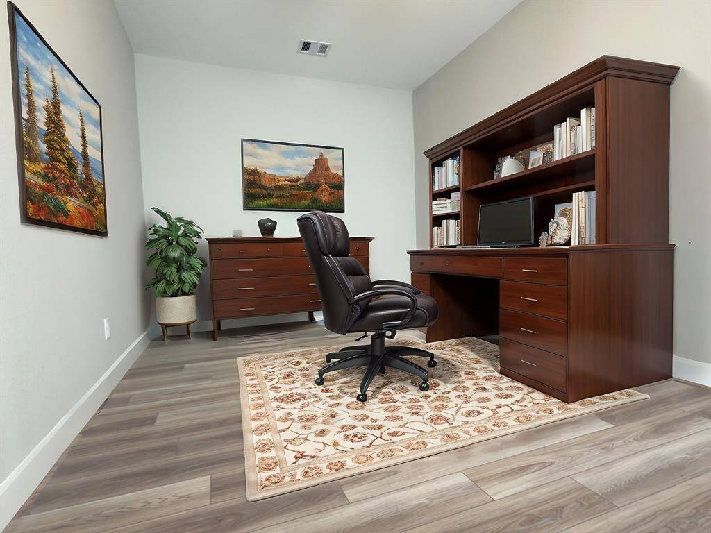The ROCburne's multi-use room is a versatile space designed to adapt to various needs, whether as a home office, entertainment area, or media room. *Image depicts home as-is virtually staged.