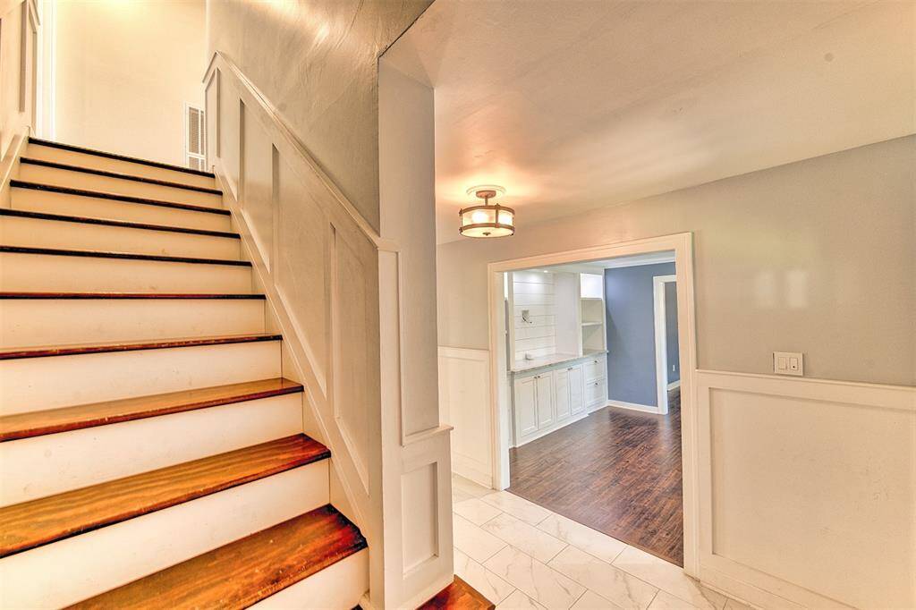 Nice updated staircase that brings you to another 3 bedrooms and full bath upstairs.