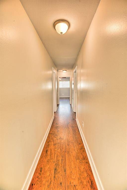Hall way leading to 3 upper bedrooms with full bath. The Bath is updated upstairs as well.