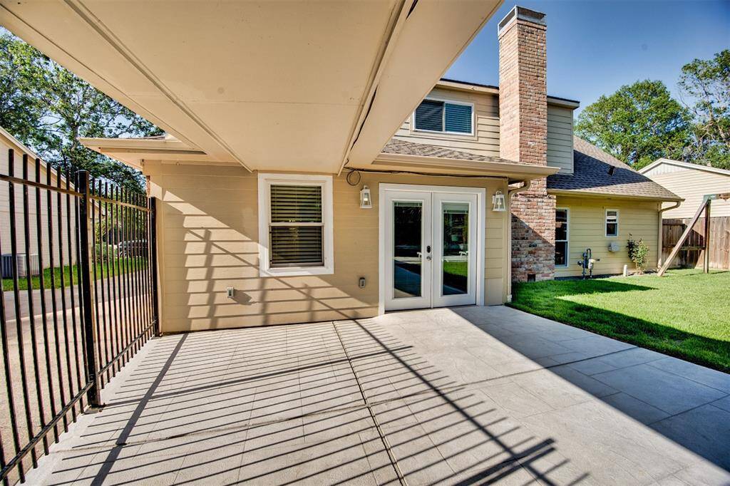 Back yard view of the home, the windows and doors all updated as well.  The home is secured by fencing.  Please come take a tour soon.  This one will not last long.