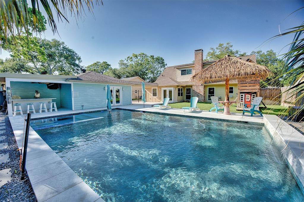 This beautiful home offers a beautiful pool, the pool has a heater and a cooler which will allow you to cool the pool in the summer up to 20 degrees from exterior temp, per sellers. I also comes with bar area. The Bar is moveable on wheels so the owner will consider selling the bar and bar stools with the sale of the home.