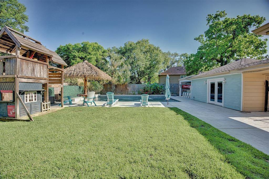 This home offers a large green space. The play house will NOT remain with the home. The detached garage offers a office or work shop with AC.