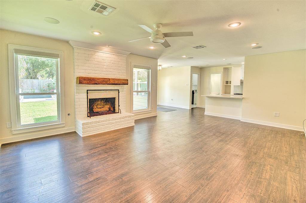 The home provides a large open feel between the main living area and kitchen. There is a half bath off the kitchen and an interior utility room with a sink, it is very spacious.