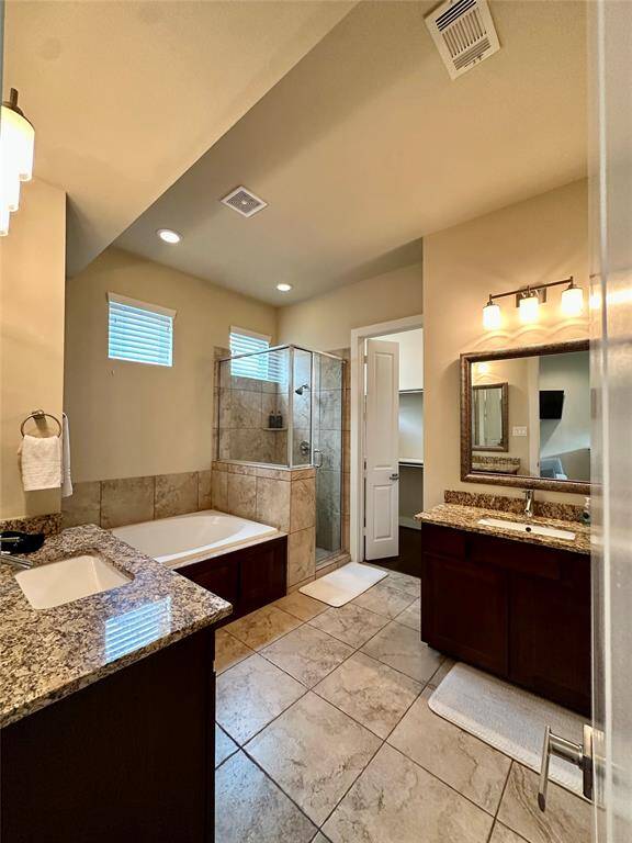 Private en-suite bath right off the master bedroom featuring many elegant features which include: marble counter tops, double separate sinks, separate spa like tub and large walk-in shower plus a spacious walk-in closet.