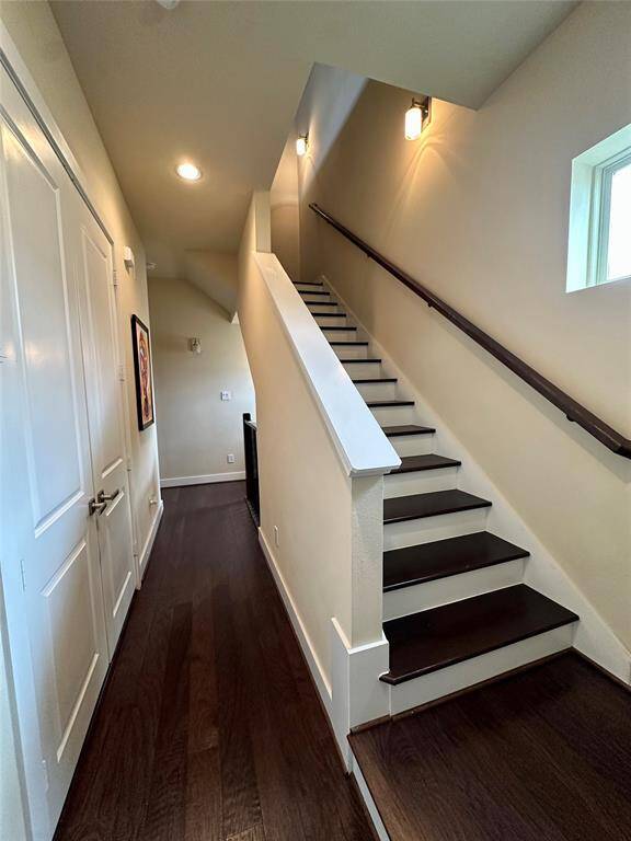 Hard wood stairs on all floors with wrought iron detailing. Doors on left to full size washer/dryer utility closet conveniently located on 3rd floor with the primary and secondary bedroom.