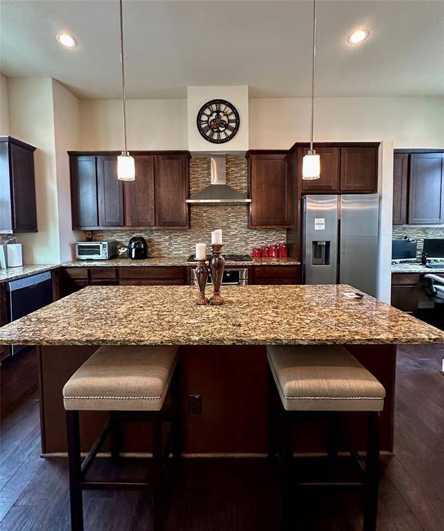 The kitchen includes Bosch appliances and lots of cabinets.