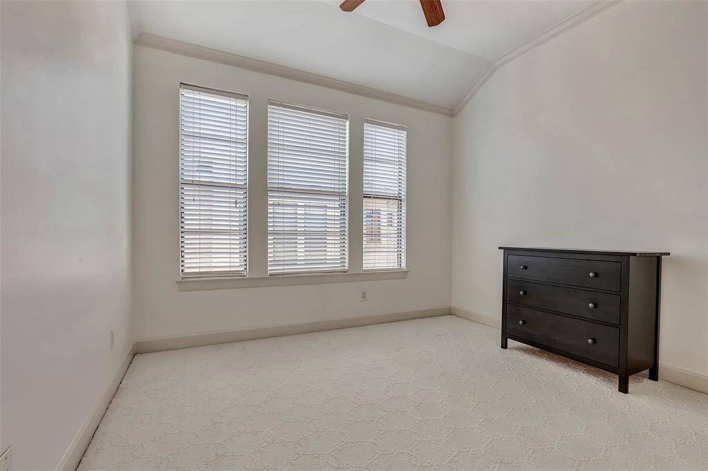 This secondary bedroom located on the third floor has tons of natural light and an ensuite bathroom.