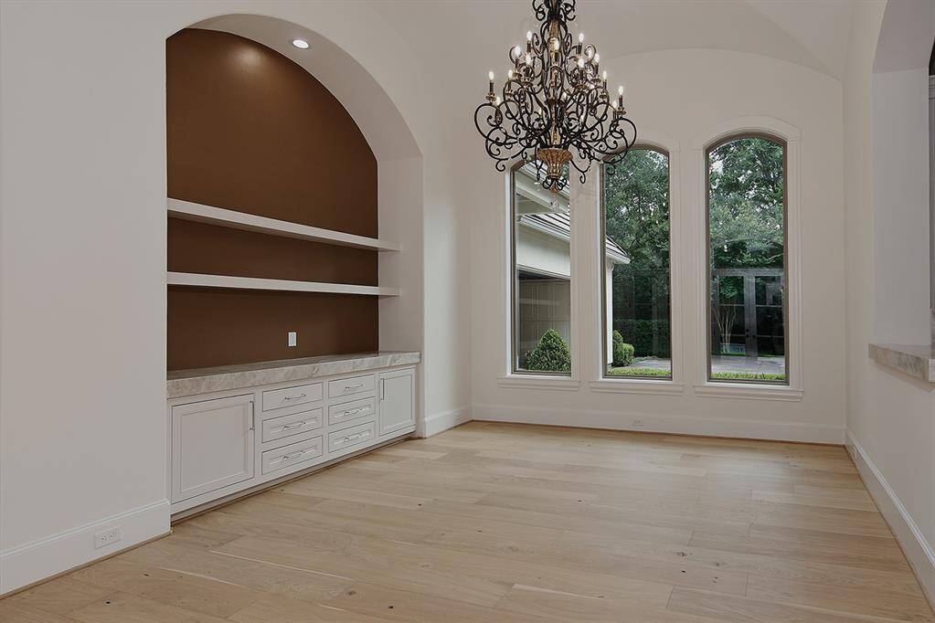 This dining area off the kitchen features a built-in buffet with quartzite counters and floating shelves.