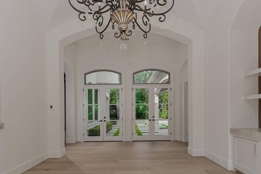 The dining area off the kitchen features beautiful pool and backyard views from the dual French doors.