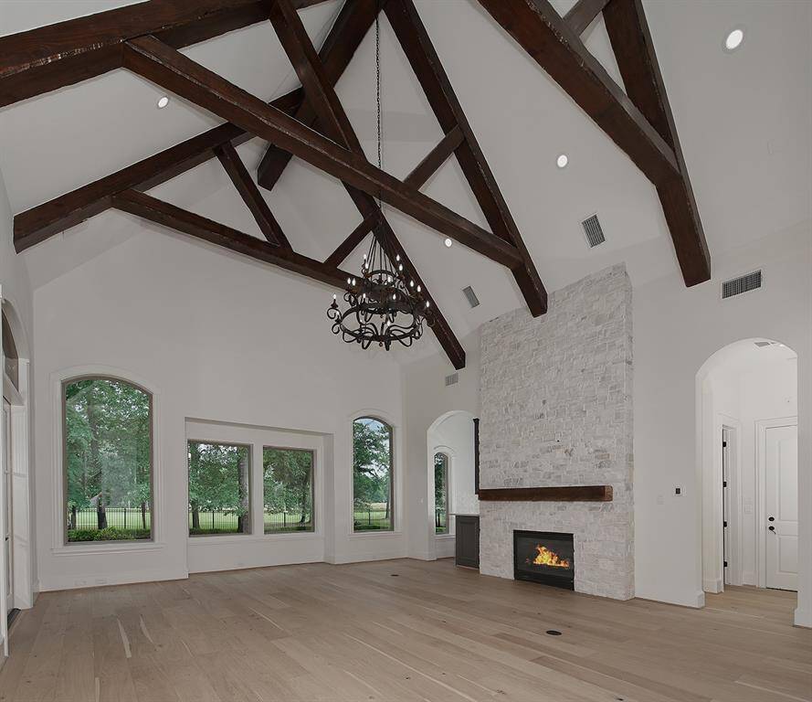 This game room downstairs offers panoramic golf course views, a wet bar, guest bath and floor to ceiling stone fireplace.