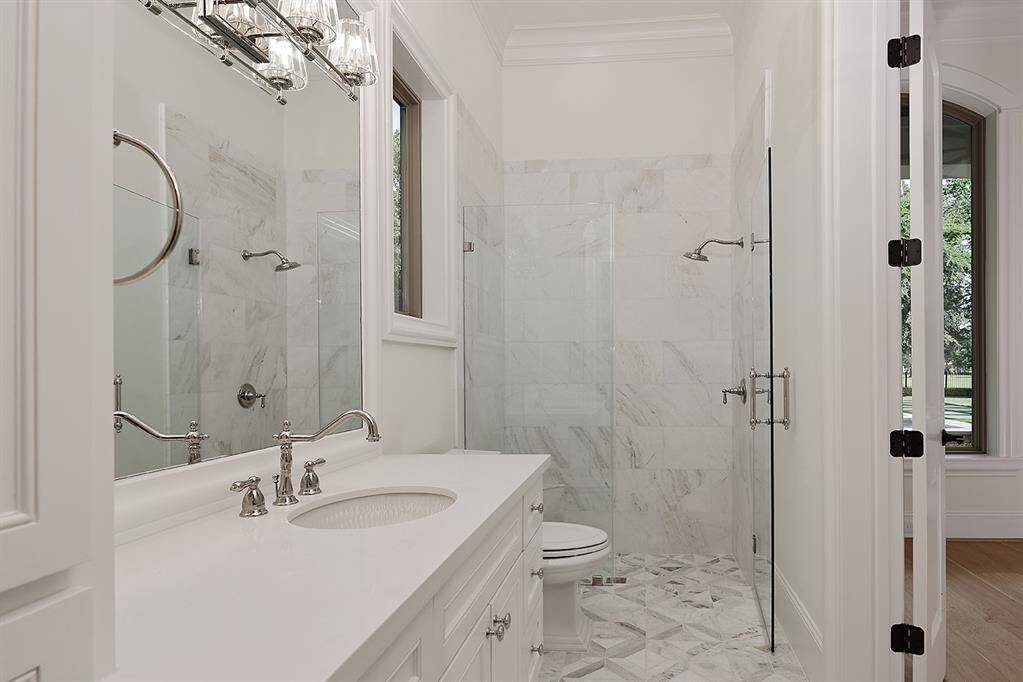 This remodeled downstairs guest suite bathroom has a step in shower, perfect for in-laws, and a walk-in closet with washer/dryer hook up.