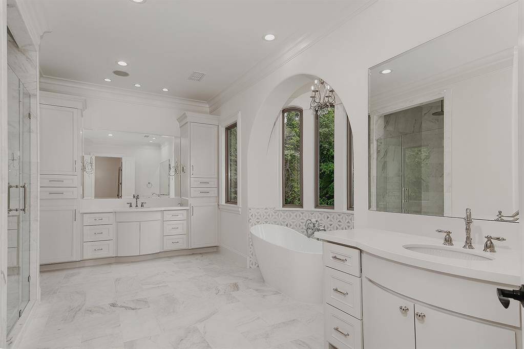 The primary bathroom is exquisite - a free standing soaking tub, enormous shower, dual sinks and walk-in closets with custom built-ins.