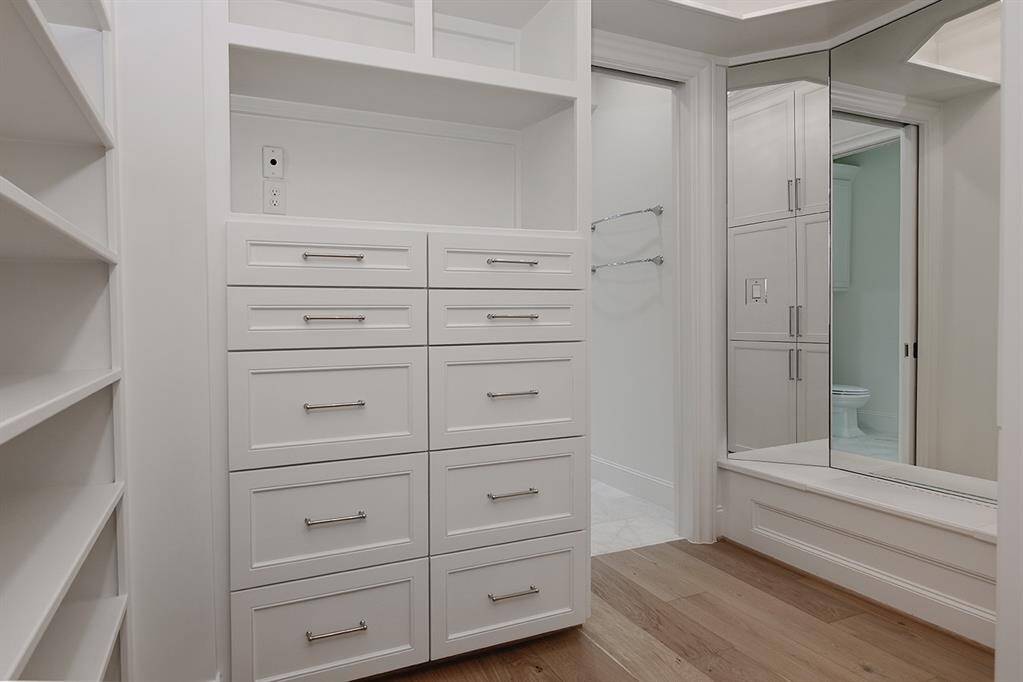 Showcasing some of the built-ins in one of the walk-in closets in the primary bath.