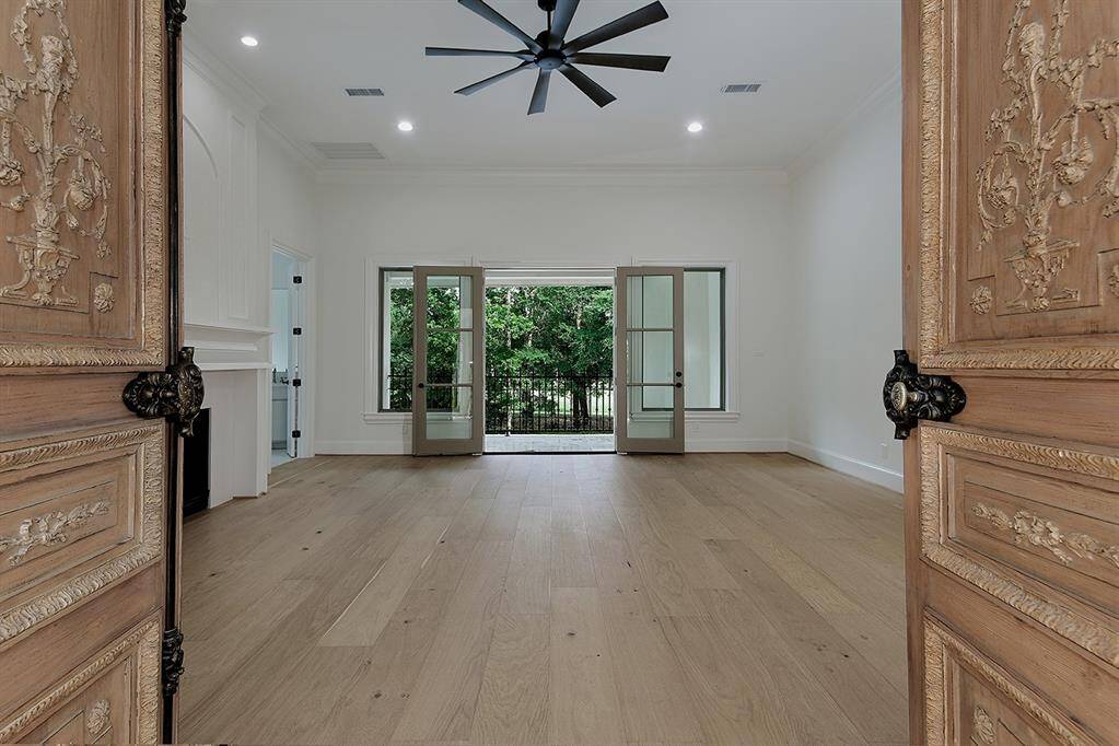 Hand carved dual entry doors lead to the primary suite upstairs - tucked away for privacy, with incredible golf course and pool views from the private balcony.