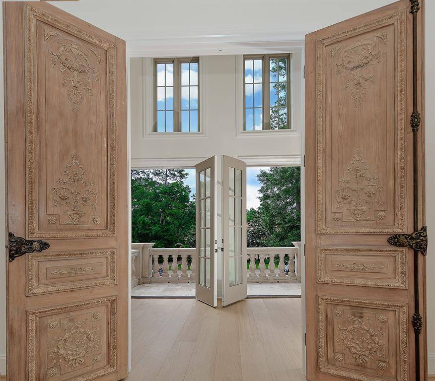 As you leave the primary suite, there are dual doors that lead to the balcony overlooking the front of the home. Every angle from this estate is breathtaking!