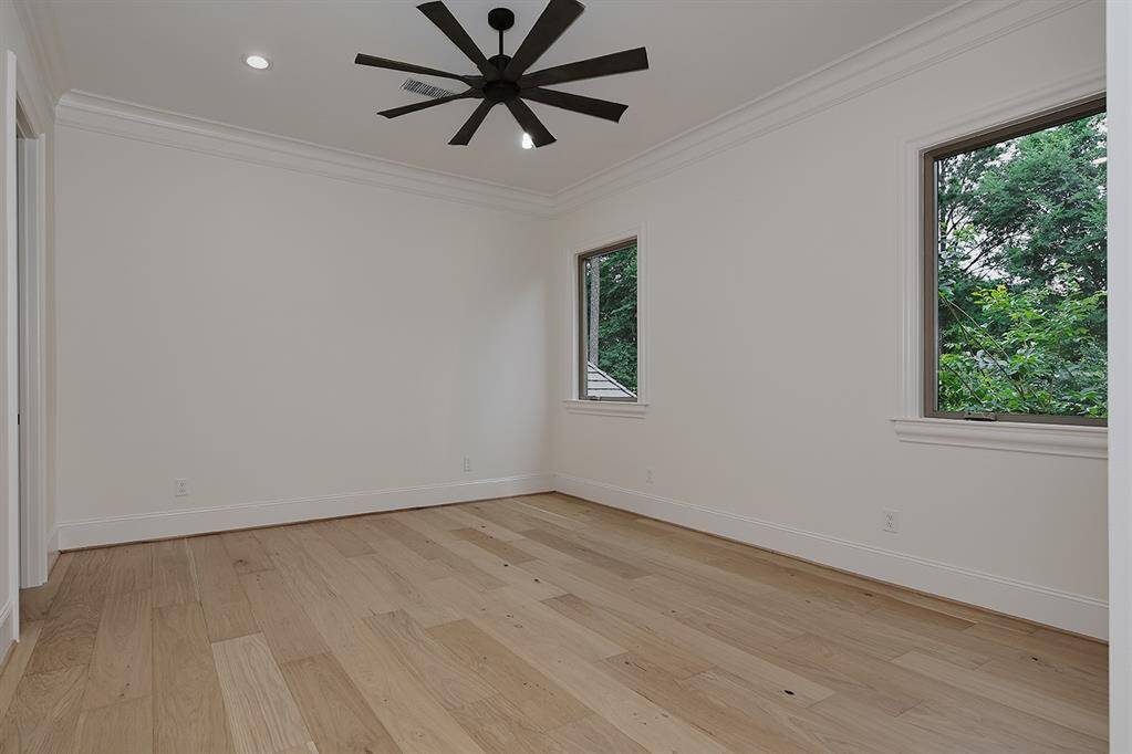 One of the guest bedrooms upstairs - notice the high ceilings and crown moulding, as well as new ceiling fan and LED canned lights.