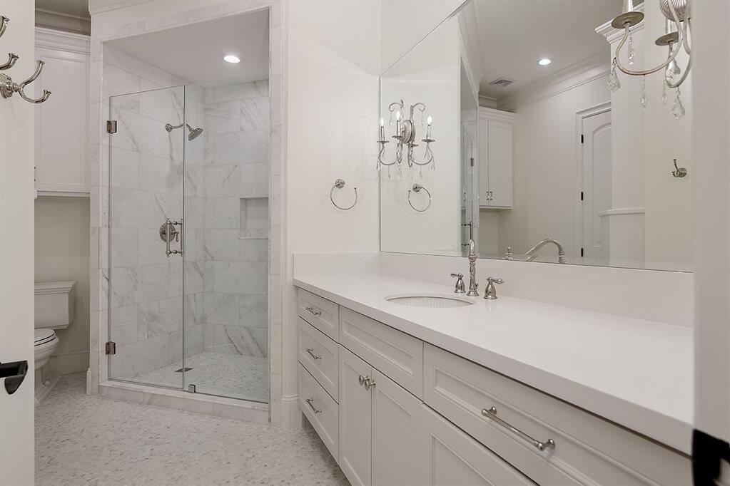 This guest bathroom upstairs features an enormous walk in closet.