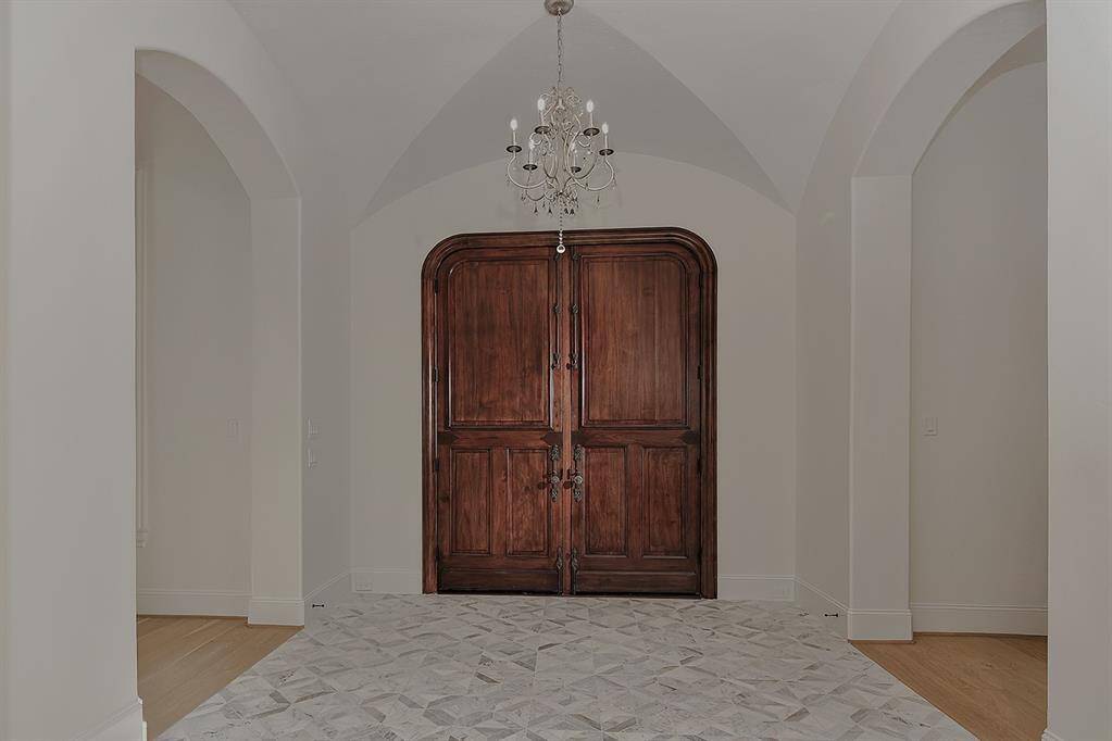 Dual solid wood entry doors lead you inside to this reimagined masterpiece!