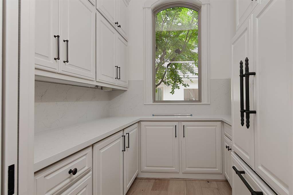 This catering area off the kitchen has a 2nd refrigerator and plenty of prep space.