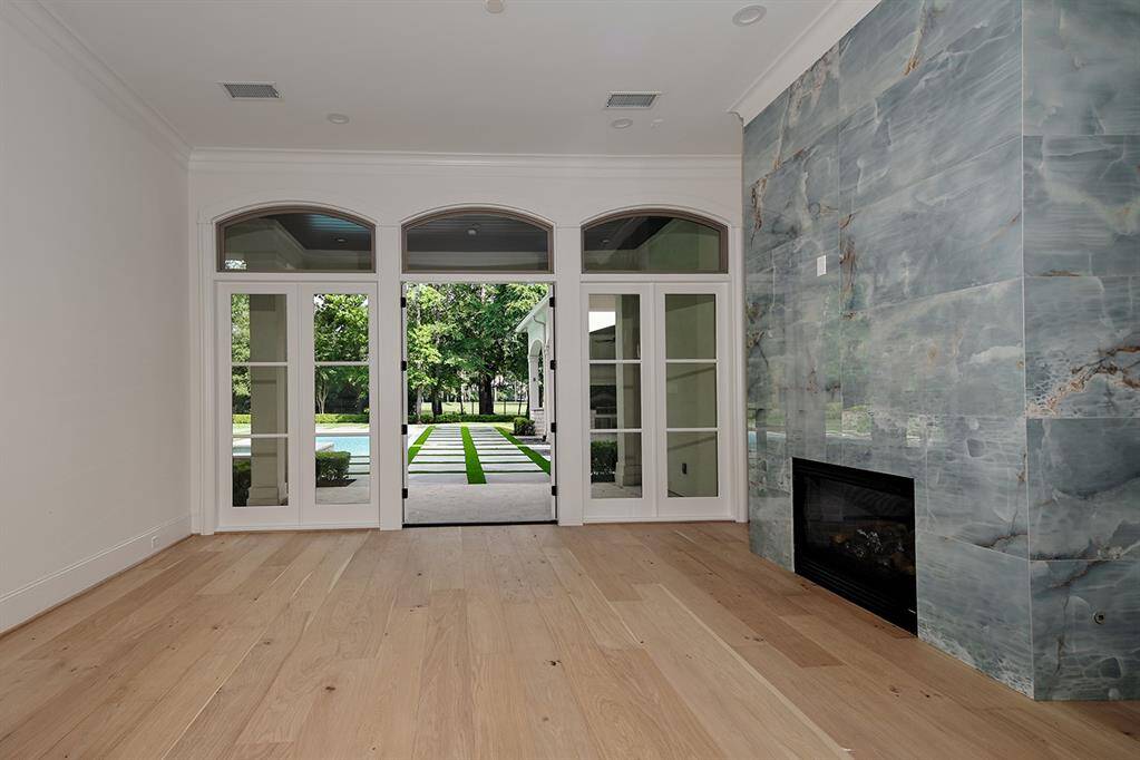 The formal living room is the first room you see as you enter the home, with a refaced fireplace and stunning views of the serene pool and spa in the backyard.