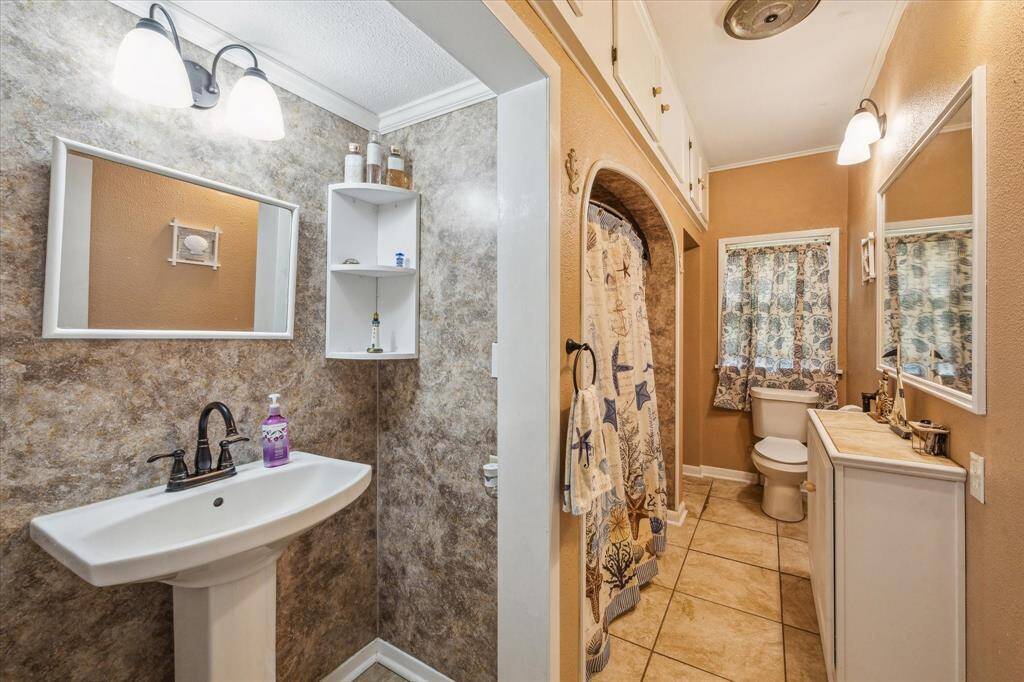 Updated with care while keeping the best original features—like the extended ceramic tub they just don’t make anymore. Built-in storage above the tub and a unique wall-carved sink space reflect the era of the home in the best way.