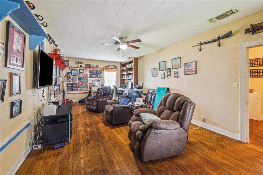 This oversized game room offers endless potential—plenty of space to divide into an extra bedroom, office, or in-law suite. Features a built-in desk with shelving on one side and original shiplap ceiling that ties in the home’s historic charm.