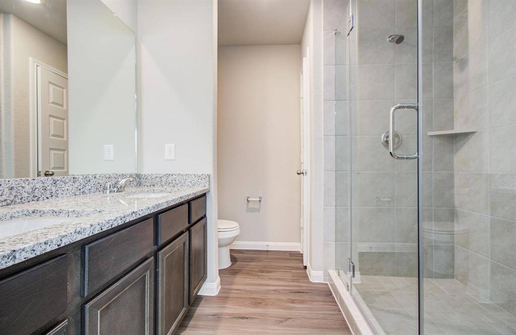 Primary bathroom with double sinks and walk in shower