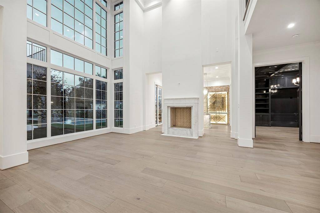 How about that view from the formal living room as you enter the home? To your right, you get a sneak peek of the Italian marble fireplace Builder brought in specifically for this home and the bar and parlor.
