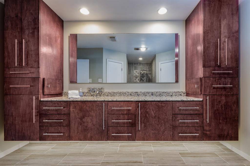 Remodeled primary bath including cabinetry.