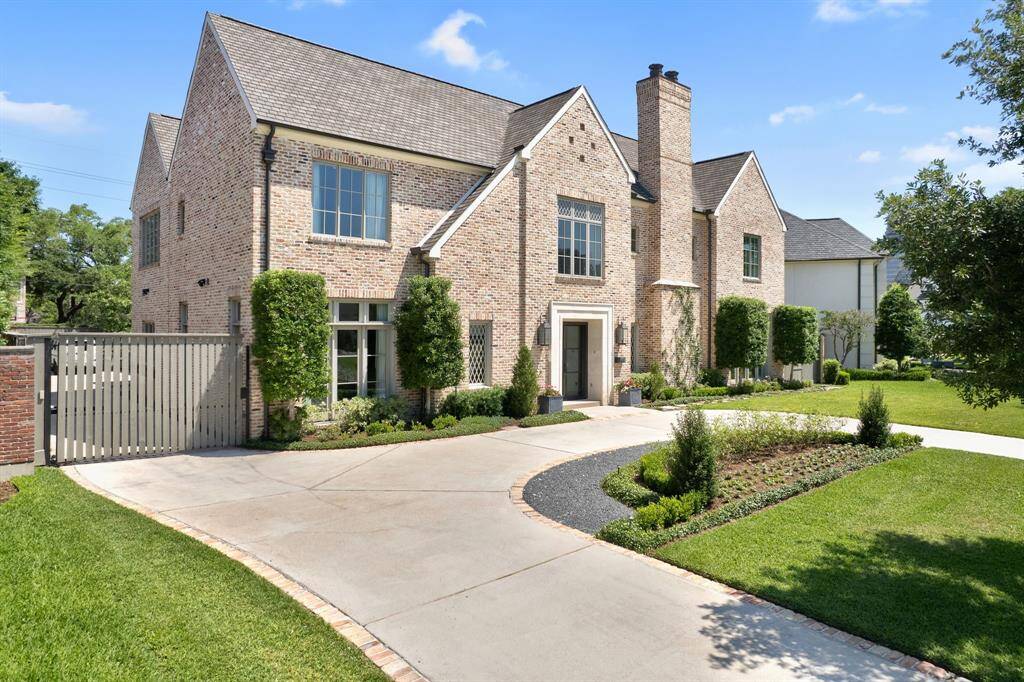 Another view of this beautifully landscaped residence, showcasing the spacious circle driveway—offering both impressive curb appeal and convenient guest parking.