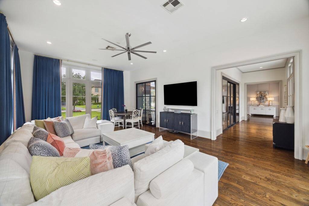 This final view of the playroom showcases its seamless flow into the front hallway and adjacent office.
