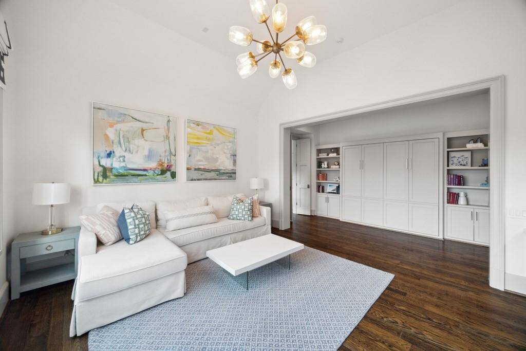 Another view of the upstairs flex room reveals a built-in Murphy bed, seamlessly integrated into custom cabinetry.