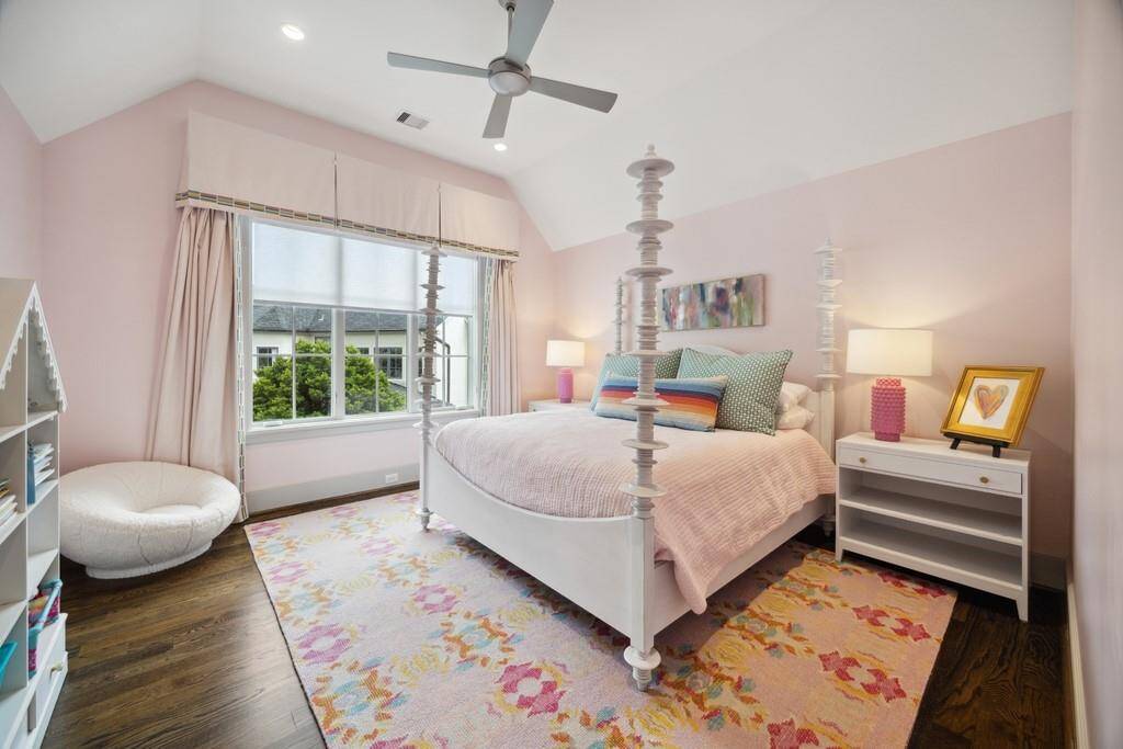 One of five bedrooms, this spacious suite features large windows, hardwood floors, a walk-in closet and a private en-suite bath.