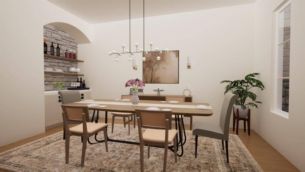 Imagine hosting dinner parties in this elegant dining space, complete with a built-in bar, stone accent wall, and statement lighting. Rendering provided by custom home builder to show renovation potential.