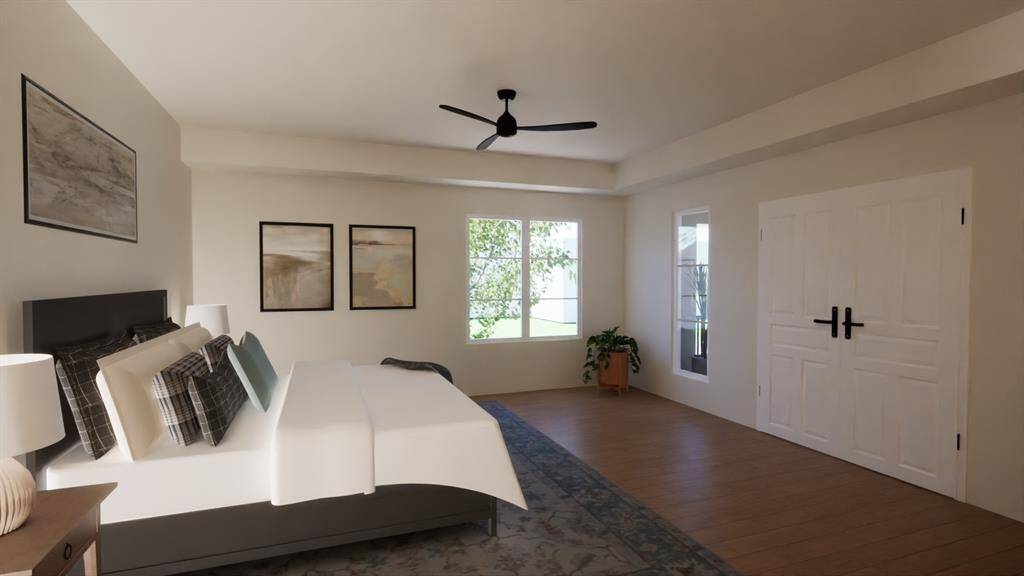 The spacious primary suite offers room to relax and recharge, with ample natural light and room for a cozy seating nook. Rendering provided by custom home builder to show renovation potential.