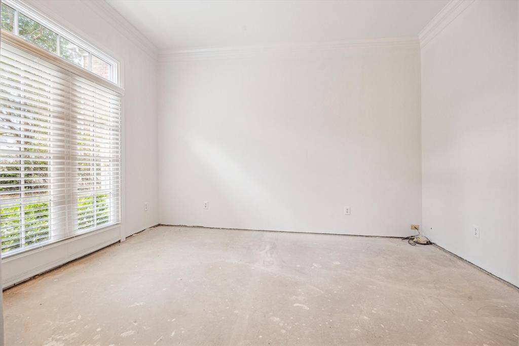 Located just off the entry, this bright and versatile room is ideal for a dedicated home office or study with front-facing windows that bring in abundant natural light.