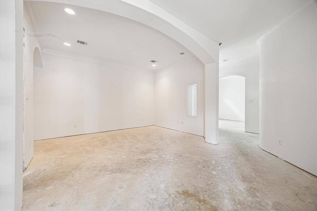 Dining room features soaring ceilings, elegant archways, and abundant natural light—ready to be transformed into the entertaining space of your dreams.