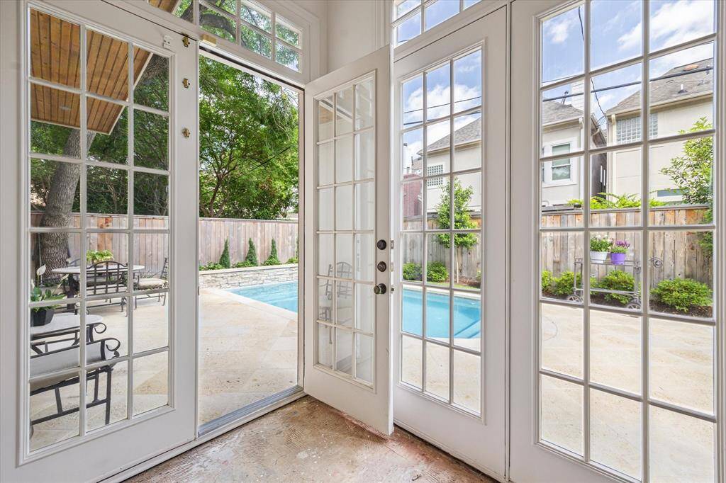 French doors in the living room open directly to the private backyard and pool area, creating seamless indoor-outdoor flow ideal for entertaining or relaxing.