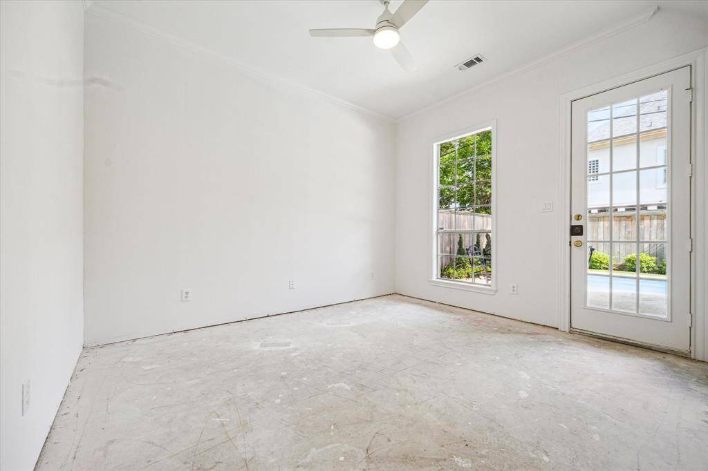 Light-filled secondary bedroom on the first floor featuring private backyard access and an ensuite full bathroom