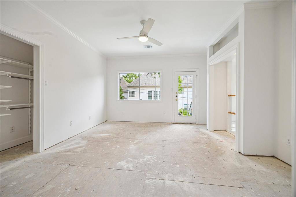Light-filled secondary bedroom on the first floor featuring private backyard access and an ensuite full bathroom