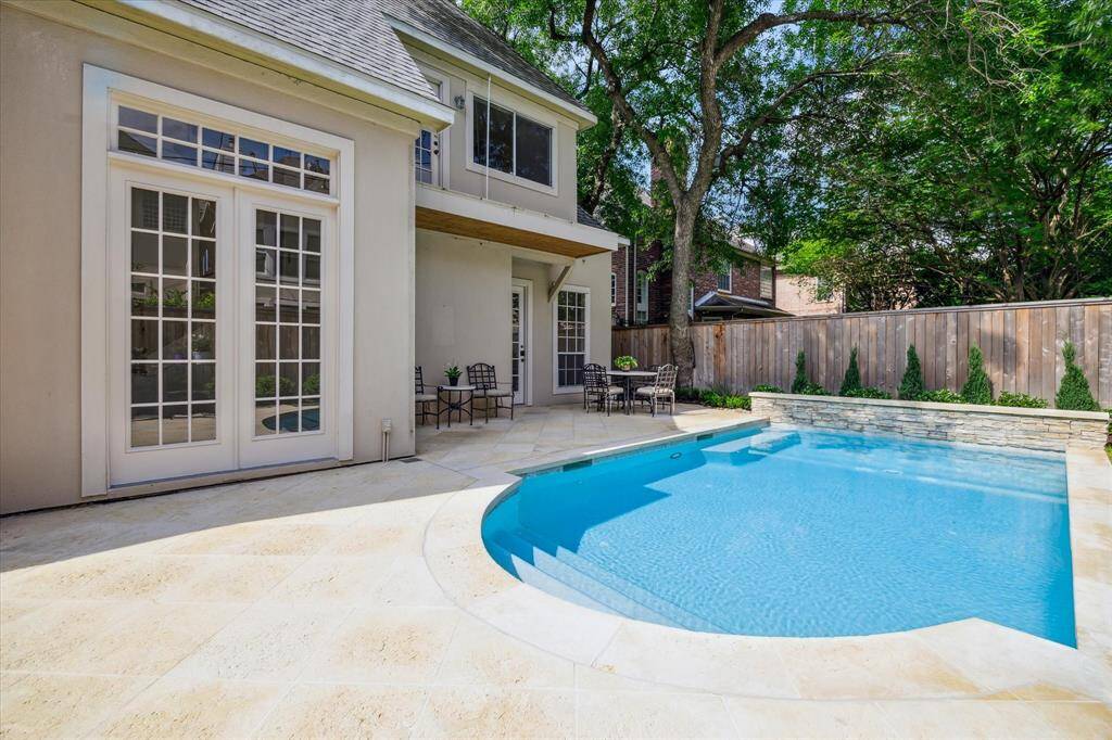 A tranquil poolside setting with plenty of space to relax, entertain, and soak in the privacy of your fenced backyard.